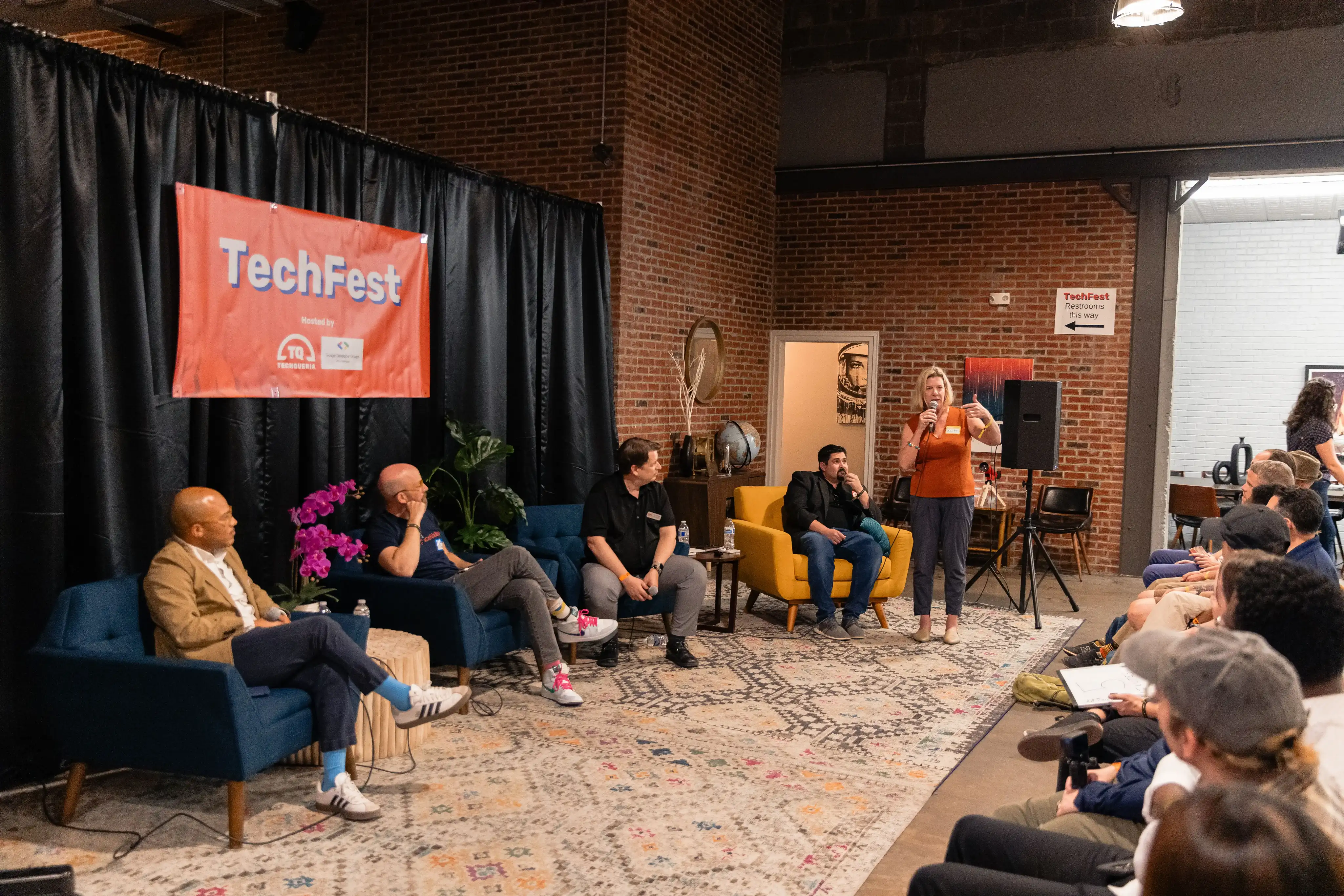 Panel discussion setup with TechFest banner and multiple speakers